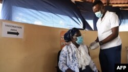 FILE - A health worker receives a dose of the Oxford/AstraZeneca COVID-19 vaccine in Francistown, Botswana, March 26, 2021. 