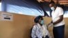 FILE - A health worker receives a dose of the Oxford/AstraZeneca COVID-19 vaccine in Francistown, Botswana, March 26, 2021. 