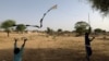 FILE - Sudanese refugees, who have fled the violence in Sudan's Darfur region, fly a handmade kite near the border between Sudan and Chad in Koufroun, Chad May 15, 2023. 