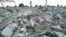 An unidentified boy goes through the rubble of a demolished small to medium business centre in Chitungwiza, 9 km (5 miles) south of Harare, Zimbabwe, June 22, 2005. 