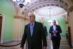 Senate Minority Leader Mitch McConnell, R-Ky., arrives to speak to reporters ahead of a test vote on a bipartisan infrastructure deal senators brokered with President Joe Biden, in Washington, July 21, 2021.