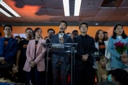 Future Forward Party leader Thanathorn Juangroongruangkit, center, speaks during a press conference after a Thailand's Constitutional Court ordered his party dissolved, in Bangkok, Thailand, Feb. 21, 2020.