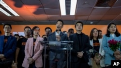 Future Forward Party leader Thanathorn Juangroongruangkit, center, speaks during a press conference after a Thailand's Constitutional Court ordered his party dissolved, in Bangkok, Thailand, Feb. 21, 2020. 