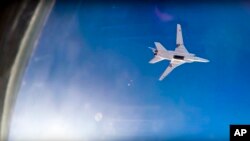 FILE - In this frame grab from video provided by Russian Defence Ministry press service, Russian long-range bomber Tu-22M3 flies during an airstrike over Aleppo region of Syria, Aug. 16, 2016. 