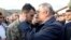 Turkish Defense Minister Hulusi Akar speaks with the brother of Halil Ibrahim Akkaya, one of 33 Turkish troops killed in Syria’s Idlib region during airstrikes, in Bahce, Osmaniye, Turkey, Feb. 28, 2020.