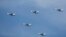 FILE Chinese JH-7 fighter-bombers fly in formation during a parade over Beijing, China, Sept. 3, 2015. 