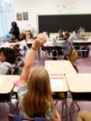 FILE - A student raises their hand in a classroom at Tussahaw Elementary school Aug. 4, 2021, in McDonough, Georgia.