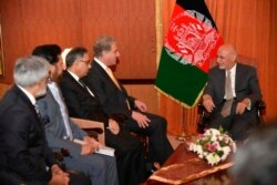 In this photo released by the Foreign Office, Pakistani Foreign Minister Shah Mehmood Qureshi, second from right, talks with visiting Afghan President Ashraf Ghani in Islamabad, Pakistan, June 27, 2019.