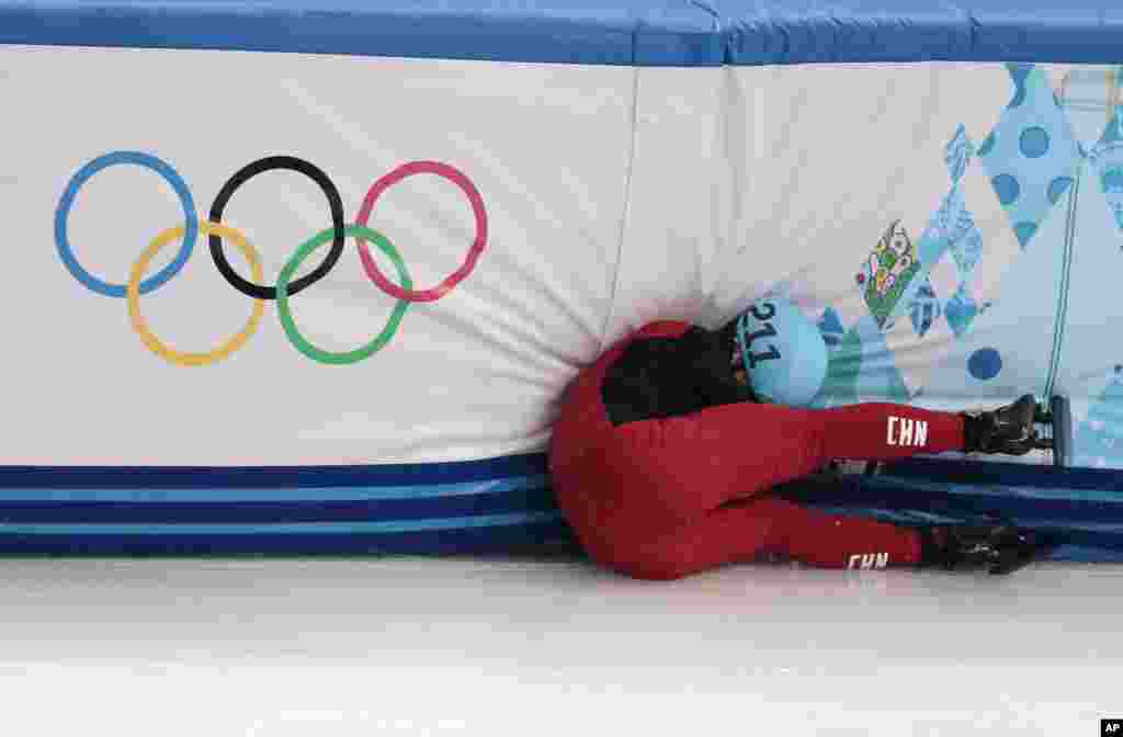 Shi Jingnan dari China menabrak pembatas di speedskating trek pendek 1.500 meter di Iceberg Skating Palace di Sochi, Rusia (10/2). (AP/Ivan Sekretarev)