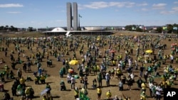 People show their support for Brazil's President Jair Bolsonaro, in Brasilia, Brazil, Sunday, July 19, 2020. Last week, Bolsonaro announced for the second time that he has tested positive for the new coronavirus.