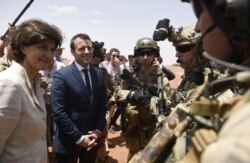 FILE - French President Emmanuel Macron meets soldiers of Operation Barkhane, France's largest overseas military operation, in Gao, northern Mali, May 19, 2017.