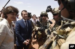 FILE - French President Emmanuel Macron meets soldiers of Operation Barkhane, France's largest overseas military operation, in Gao, northern Mali, May 19, 2017.