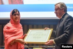 FILE - Malala Yousafzai attends a ceremony with United Nations Secretary-General Antonio Guterres after being selected a United Nations messenger of peace in New York, April 10, 2017.