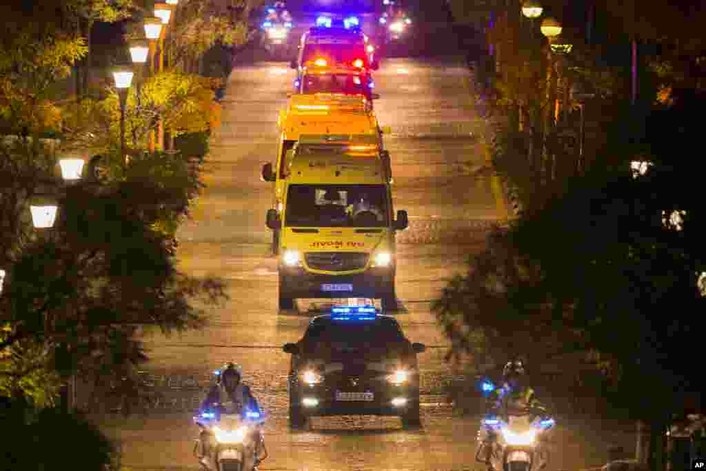 A convoy transporting a Spanish nurse believed to have contracted the Ebola virus from a 69-year-old Spanish priest leaves Alcorcon Hospital in Madrid, Spain, Oct. 7, 2014. 