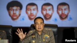 Thai national police chief Somyot Pumpanmuang gestures during a news conference September 28, 2015 about the Bangkok blast as a screen shows the different looks of a suspect, who has been referred to both as Bilal Mohammed and Adem Karadag. (REUTERS/Athit Perawongmetha) 