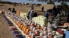 FILE - This handout photo provided by World Relief shows emergency food being distributed by World Food Program and World Relief in Kulbus, West Darfur, Sudan, in March 2024. (World Relief via AP)