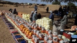 FILE - This handout photo provided by World Relief shows emergency food being distributed by World Food Program and World Relief in Kulbus, West Darfur, Sudan, in March 2024. (World Relief via AP)