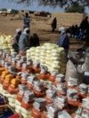 FILE - This handout photo provided by World Relief shows emergency food being distributed by World Food Program and World Relief in Kulbus, West Darfur, Sudan, in March 2024. (World Relief via AP)
