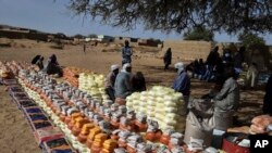 FILE—This handout photo provided by World Relief shows emergency food being distributed by World Food Program and World Relief in Kulbus, West Darfur, Sudan, end of March 2024.