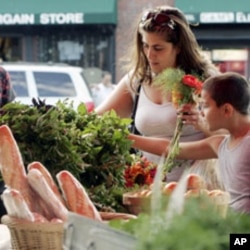 Customers shop at the Food Project's Farmer's Market in Boston's neighborhood of Dorchester, Massachusetts. Each year, The Food Project hires 60 youths to grow food on their farms, during which these teens harvest and distribute over 60,000 pounds of prod