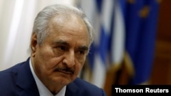 FILE - Moments before she was killed, lawyer Hanan al-Barassi had been broadcasting a live Facebook video in which she criticized allies of the east's military strongman, Khalifa Haftar, pictured above, and vowed to reveal their alleged crimes.