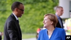 FILE - German Chancellor Angela Merkel, right, welcomes the President of Rwanda, Paul Kagame left, for a meeting at the chancellery as part of the 'G20 Africa Partnership – Investing in a Common Future' conference in Berlin, Germany, Monday, June 12, 2017.