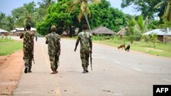 FILE: Soldiers from the Mozambican army patrol the streets after security in the area was increased, following a two-day attack from suspected islamists in October last year, on March 7, 2018 in Mocimboa da Praia, Mozambique. (Photo by ADRIEN BARBIER / AFP)