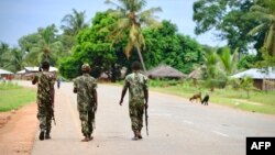 FILE: Soldiers from the Mozambican army patrol the streets after security in the area was increased, following a two-day attack from suspected islamists in October last year, on March 7, 2018 in Mocimboa da Praia, Mozambique. (Photo by ADRIEN BARBIER / AFP)