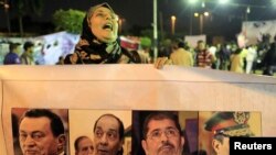 A protester, who is against the Egyptian army and government, shouts slogans during a demonstration against the army and government at Abdeen square in downtown Cairo, Nov.18, 2013.