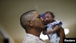 Geovane Silva et son fils Gustavo Henrique, atteint d'une microcéphalie, à l'hôpital Oswaldo Cruz de Recife, Brésil, le 26 janvier 2016. (REUTERS/Ueslei Marcelino)