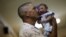 Geovane Silva holds his son Gustavo Henrique, who has microcephaly, at the Oswaldo Cruz Hospital in Recife, Brazil, Jan. 26, 2016. 