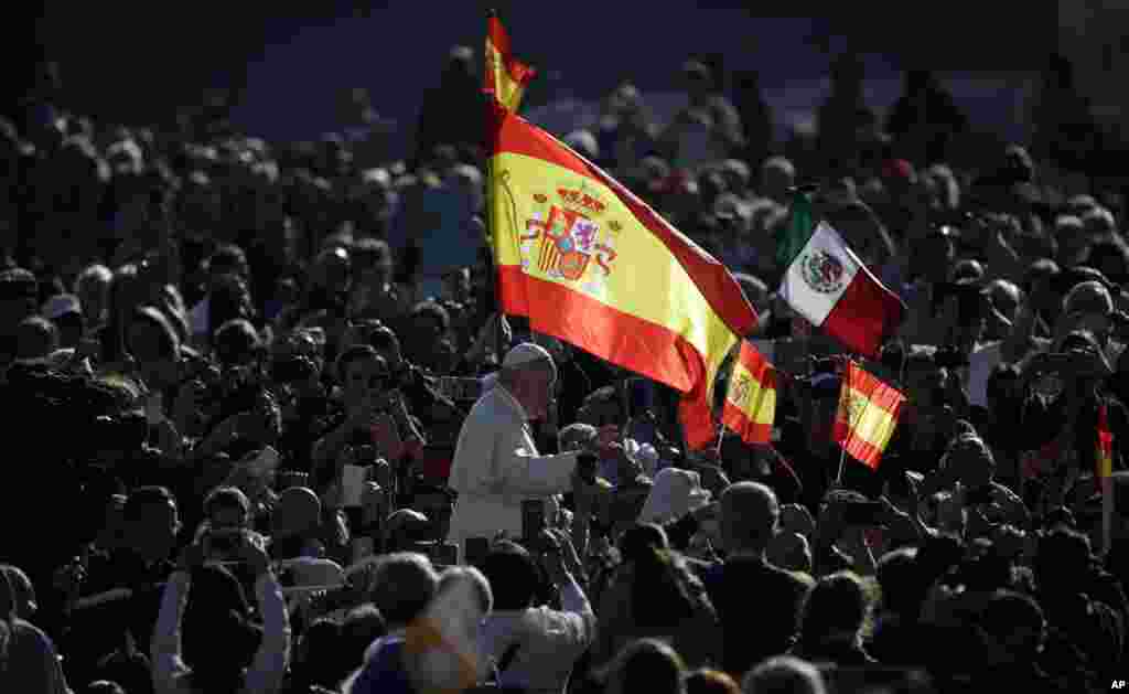 Pope Francis passes by a Spanish flags waving in the crowd during his weekly general audience, in St. Peter&#39;s Square, at the Vatican.