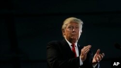 Republican presidential candidate Donald Trump applauds during a rally, Thursday, June 2, 2016.