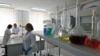 FILE - Scientists work in a laboratory in Kurchatov, Kazakhstan, Aug. 22, 2011.