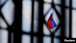 FILE - The Russian flag flies over the Embassy of Russia in Washington, Aug. 6, 2018.