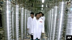 A handout picture released by the official website of Iran's presidency office shows Iranian President Mahmoud Ahmadinejad visiting the Natanz uranium enrichment facility (File)