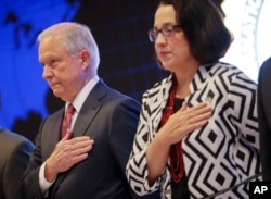 U.S. Attorney General Jeff Sessions and U.S. Ambassador to El Salvador Jean Elizabeth Manes stand during the playing of the U.S. national anthem during a graduation ceremony at the International Law Enforcement Academy in San Salvador, El Salvador, July 2, 2017.