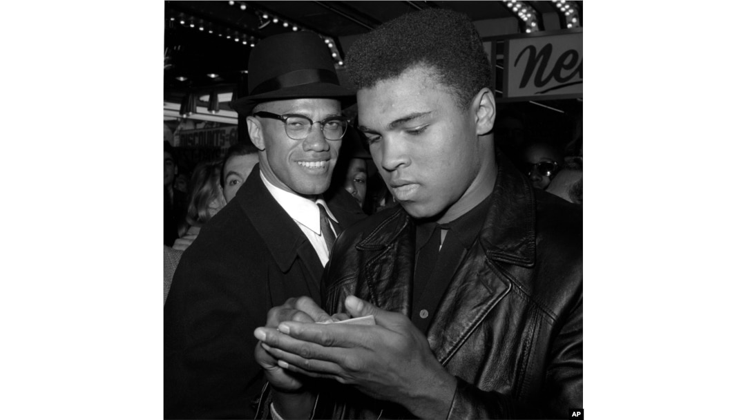 FILE - World heavyweight boxing champion Muhammad Ali, right, and Black Muslim leader Malcolm X in New York City, March 1, 1964. Ali died Friday in Phoenix, Arizona, at age 74.