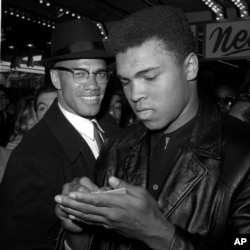 FILE - World heavyweight boxing champion Muhammad Ali, right, and Black Muslim leader Malcolm X in New York City, March 1, 1964. Ali died Friday in Phoenix, Arizona, at age 74.
