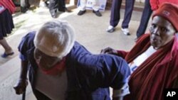 An elderly voter struggles into a polling station as the country goes to the polls in local municipal elections in Soweto, South Africa, Wednesday, May 18, 2011. (Photo/Denis Farrell)