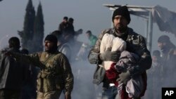 Syrians evacuated from the embattled Syrian city of Aleppo during the cease-fire arrive at a refugee camp in Rashidin, near Idlib, Syria, early Monday, Dec. 19, 2016.