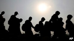 FILE - Venezuelans cross illegally into Colombia near the Simon Bolivar International Bridge, which Venezuelan authorities continue to keep closed, in La Parada near Cucuta, March 5, 2019. 