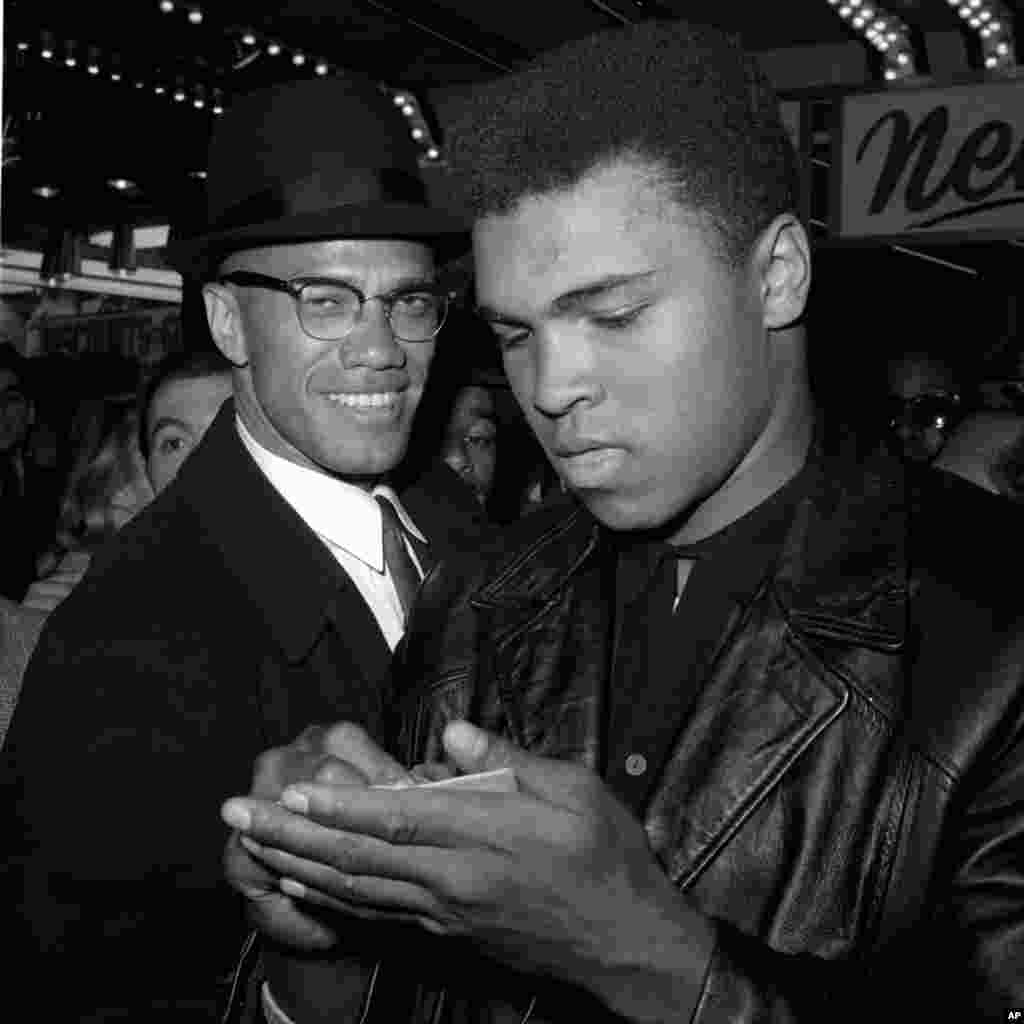 FILE - World heavyweight boxing champion Muhammad Ali, right, and Black Muslim leader Malcolm X in New York City, March 1, 1964. Ali died Friday in Phoenix, Arizona, at age 74.