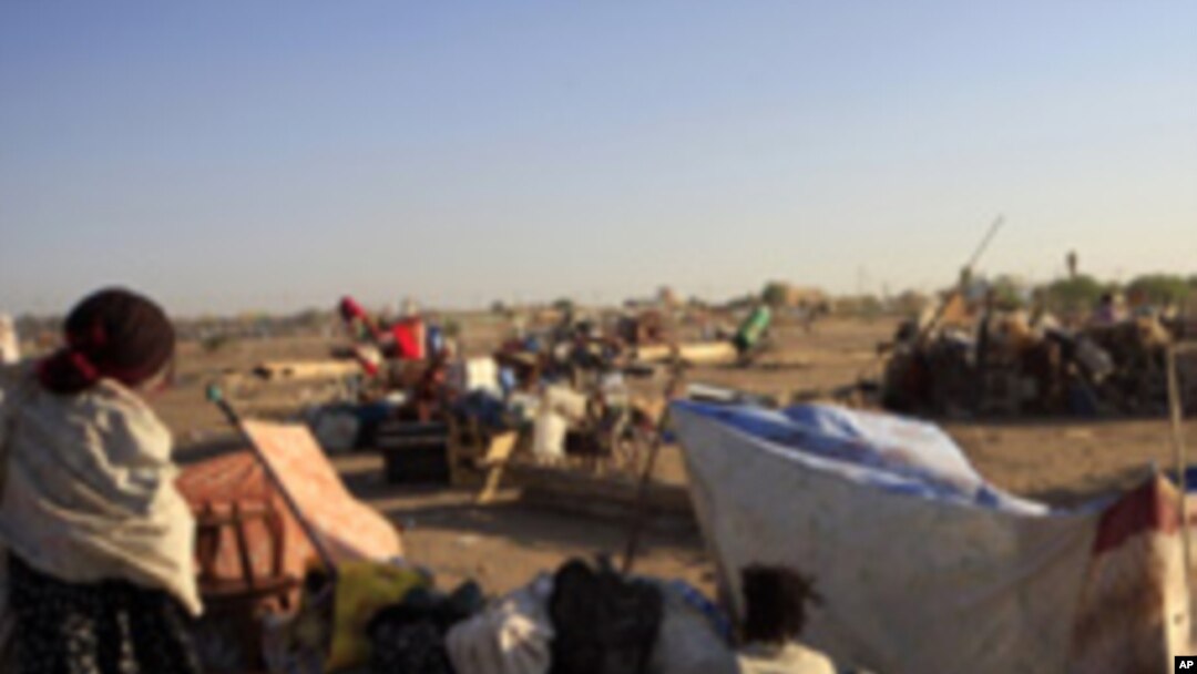 A family from southern Sudan, who has been staying in the north for 21 years, waits in Khartoum to be transported in a convoy back to the Abyei oil region. Southern.