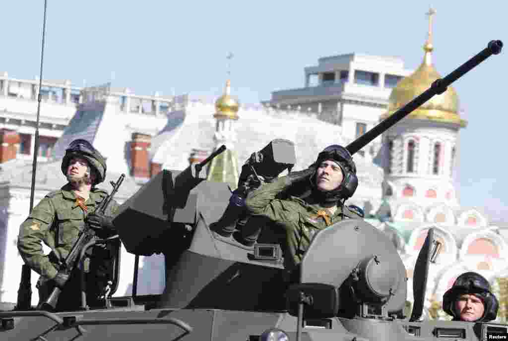 A Russian serviceman salutes during the Victory Day Parade in Moscow's Red Square, May 9, 2014.