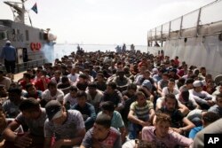 FILE - Migrants are detained at Abosetta base in Tripoli, Libya, May 10, 2017.