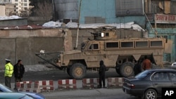 A U.S. military vehicle drives on the road leading to the Afghan Interior Ministry in Kabulو February 25, 2012.
