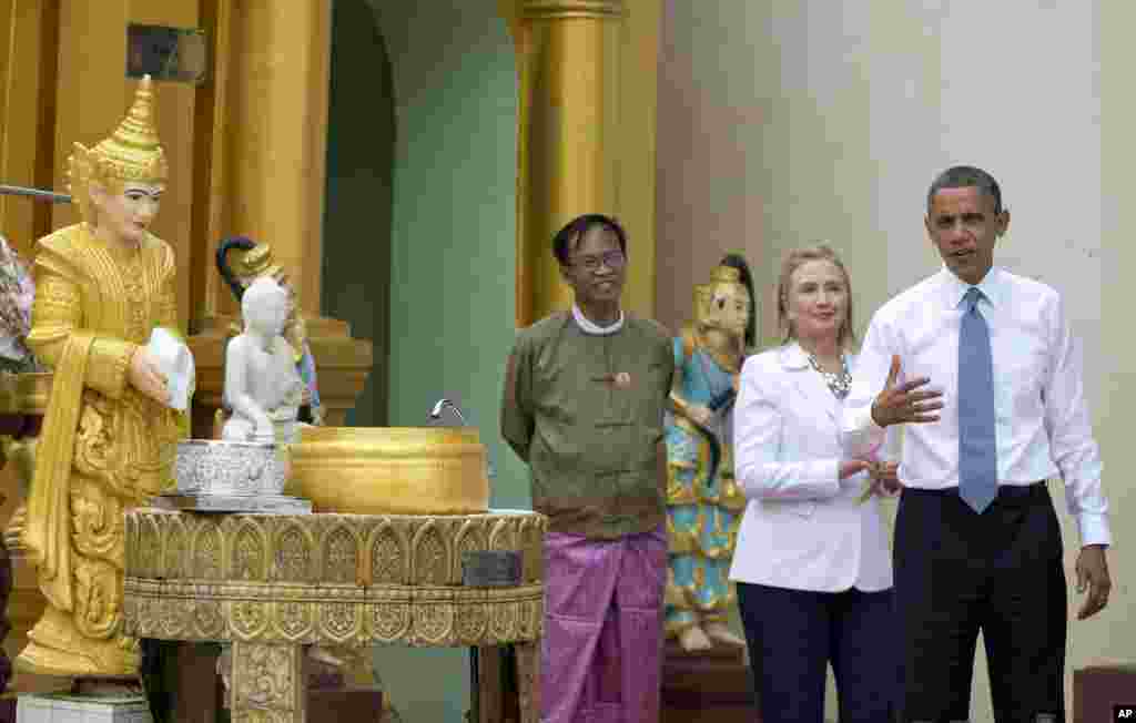 US President Barack Obama speaks to the media after he "doused eleven flames" as he tours the Shwedagon Pagoda with Secretary of State Hillary Rodham Clinton in Rangoon, Burma, November 19, 2012. 