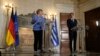 German Chancellor Angela Merkel speaks next to Greek Prime Minister Kyriakos Mitsotakis during a join news conference after their meeting at Maximos Mansion in Athens, Greece, Oct. 29, 2021.