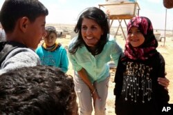 U.S. Ambassador to the United Nations Nikki Haley, speaks with Syrian refugee children, during a visit to the Zaatari Refugee Camp, Jordan, May 21, 2017.